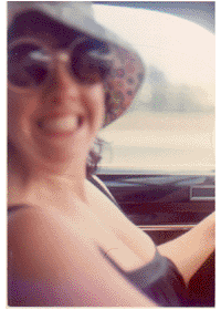 Barbara Rosenbaum - driving ...Photo provided by Keven Bridge.  Keven writes:Here's a photo of Barbara Rosenbaum driving (circa 1971-1973). Barbara writes, "As ownership was theft in those days, the hat was probably only on my head temporarily. However, in contradiction to the above, the car was mine, and Keven reminds me (how had I forgotten?) that it was named Tyrone." 